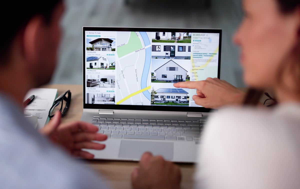 Family reviewing real estate and housing options on laptop — parent rent-vs-buy decision near Penn State University