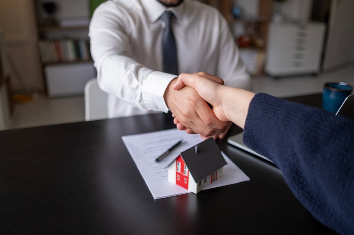 Professional local real estate expert reviewing campus-area property with clients
