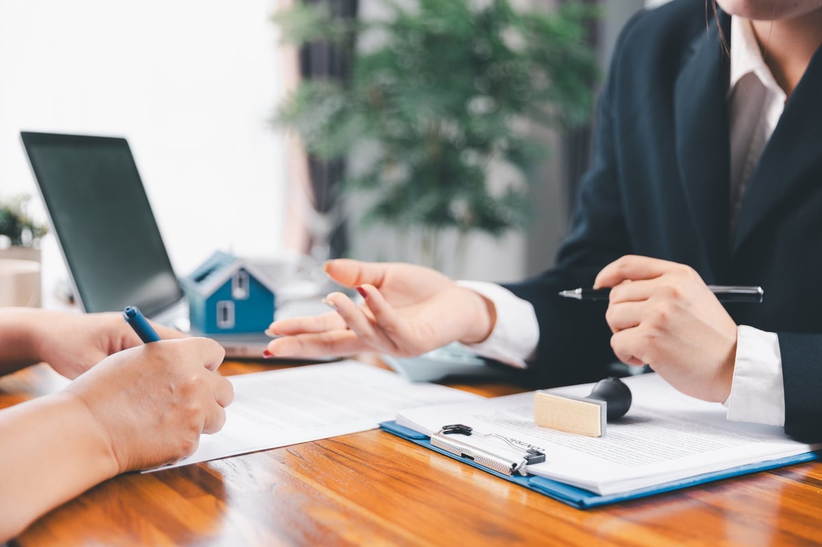 Parents discussing campus-area home purchase financing with mortgage advisor